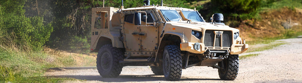 Military vehicle on sand, retrofitted with EMI shielding using flame-retardant Hook-N-Shield.